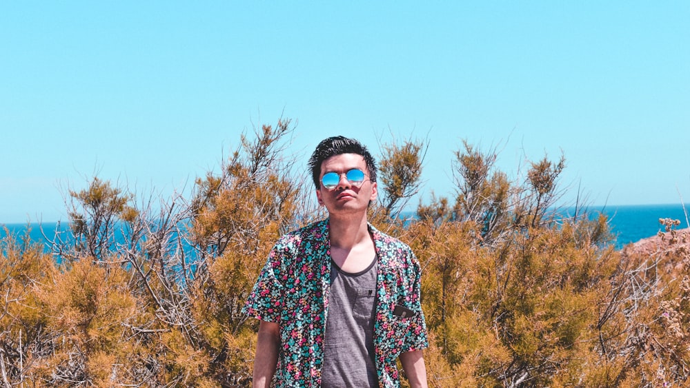 man in pink and blue floral button-up shirt