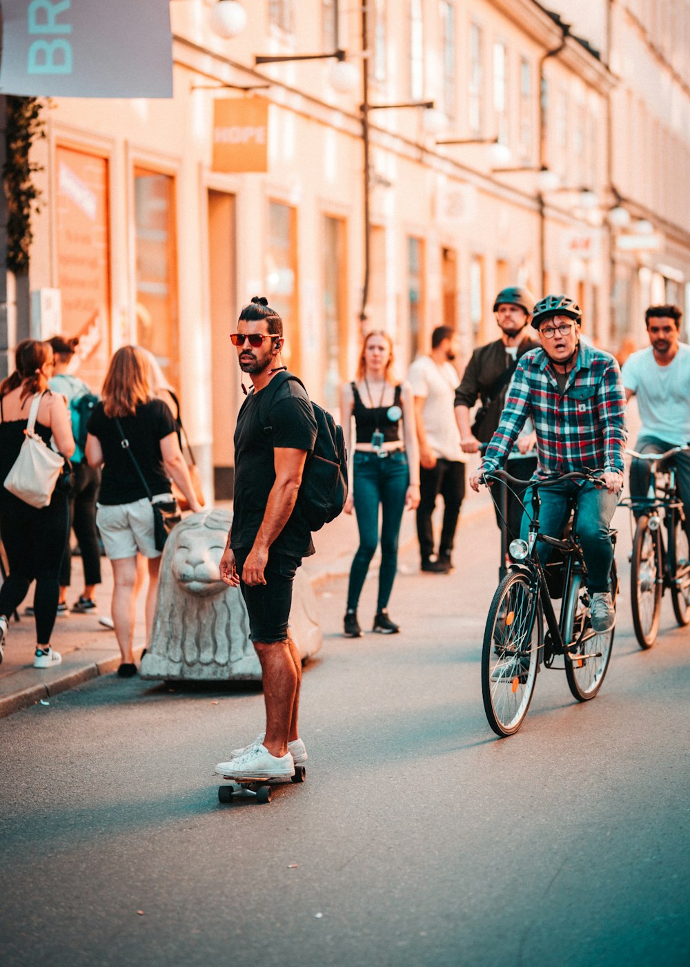 man standing on skateboard near people