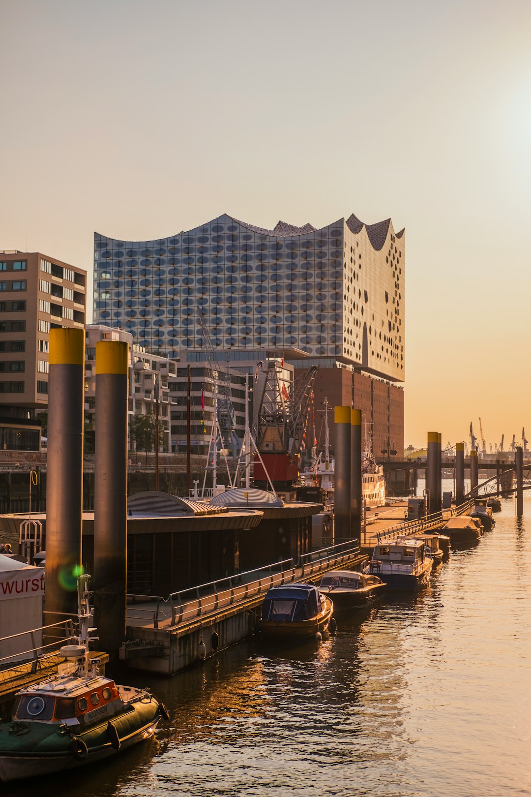 boats near beach dock viewing high-rise buildings during daytime