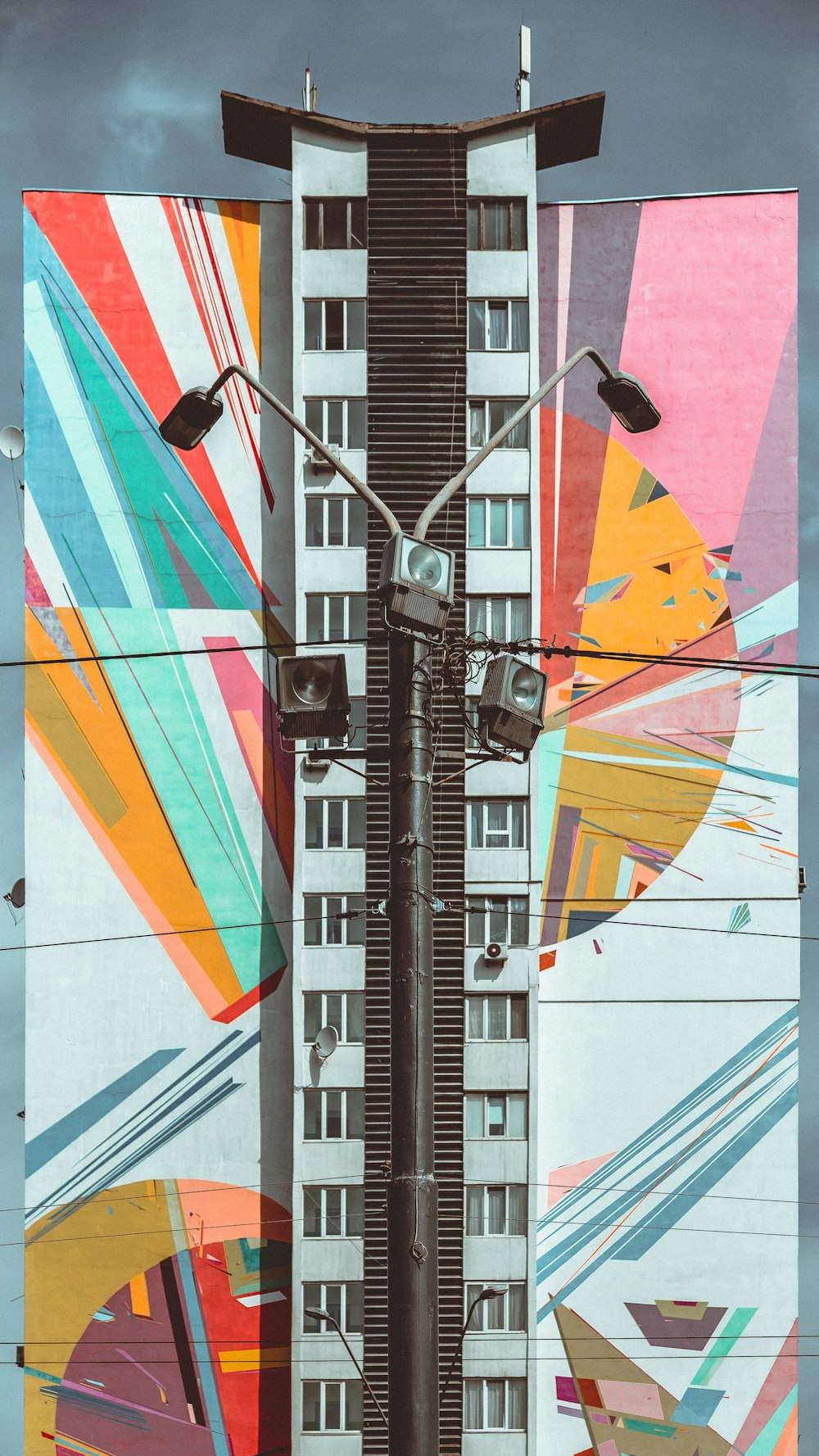 a tall building with a mural on the side of it