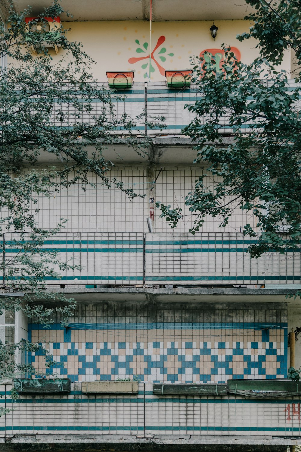 white and green concrete building near green leaf plants