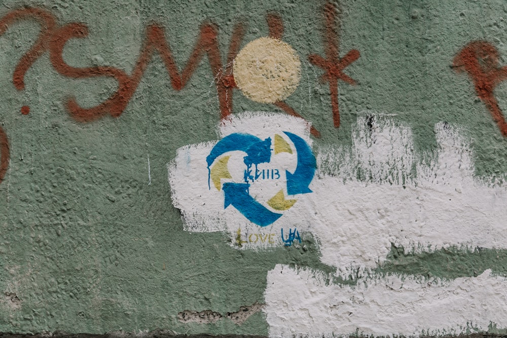 graffiti on the side of a building with a white fire hydrant