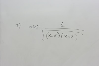 A section of a whiteboard features a mathematical expression written in black marker. The expression depicted is h(x) = 1 / √((x-8)(x+2)), which suggests a function involving variables and parentheses. The board is otherwise clean, with no additional markings or annotations.
