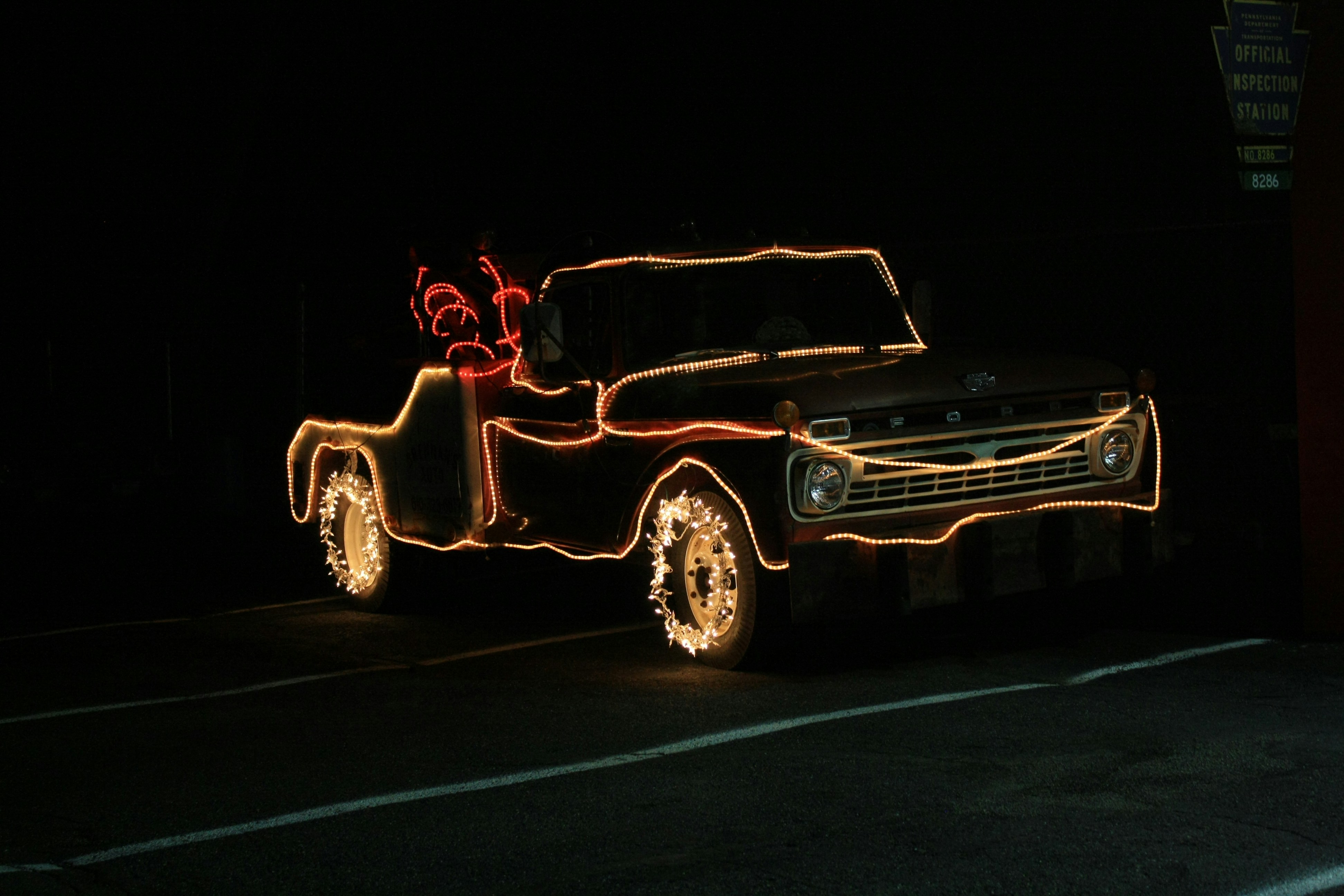 Car covered in red and yellow string lights photo Free Christmas