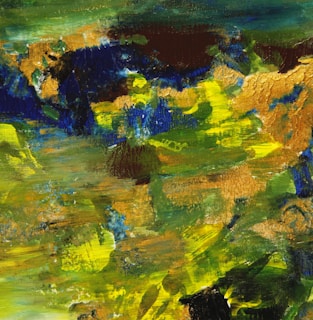 An abstract artwork featuring bold brush strokes in blue, green, and yellow.