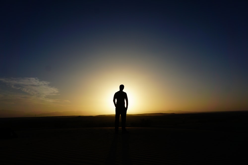 person standing at the field during golden hour