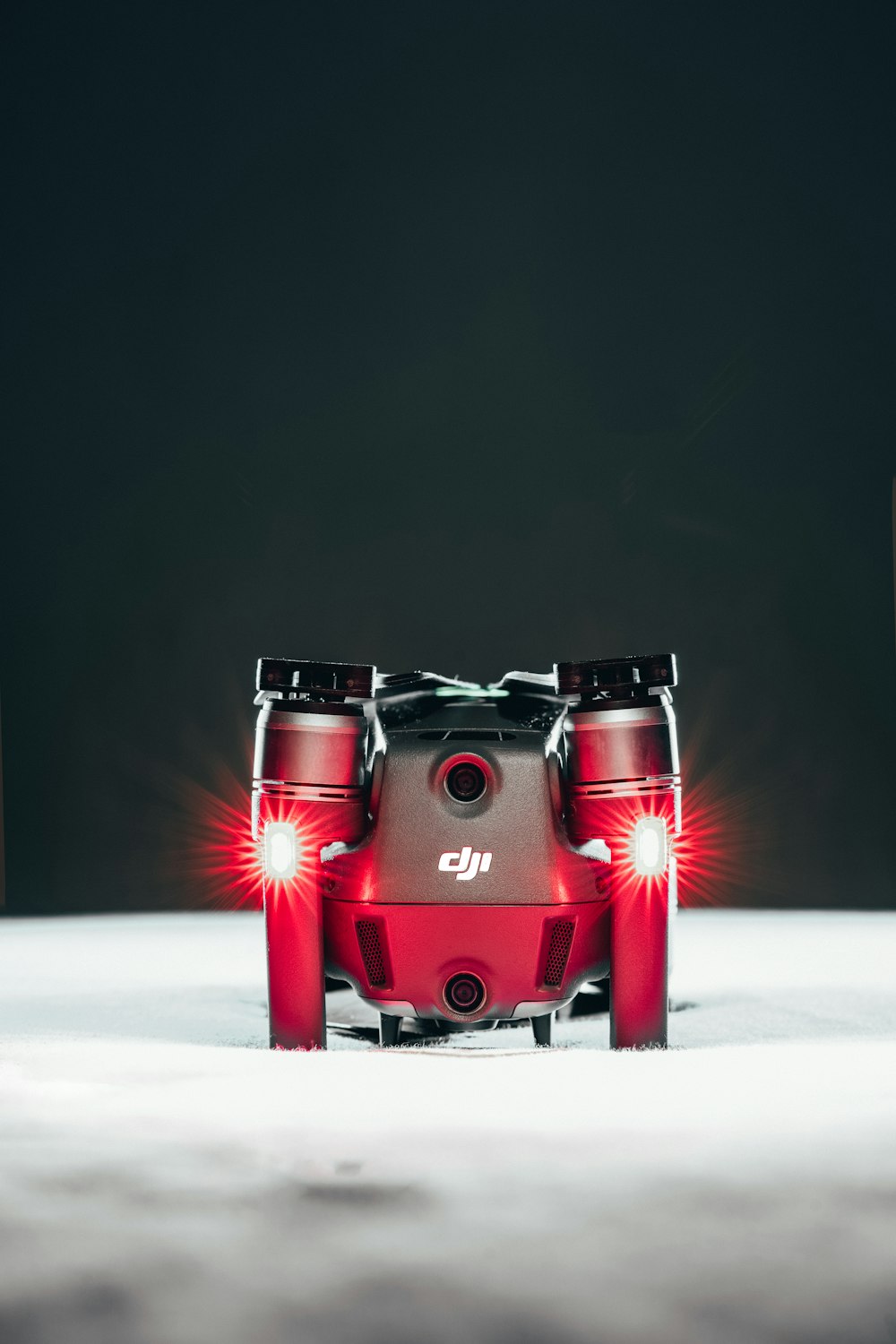 a red camera sitting on top of a white table