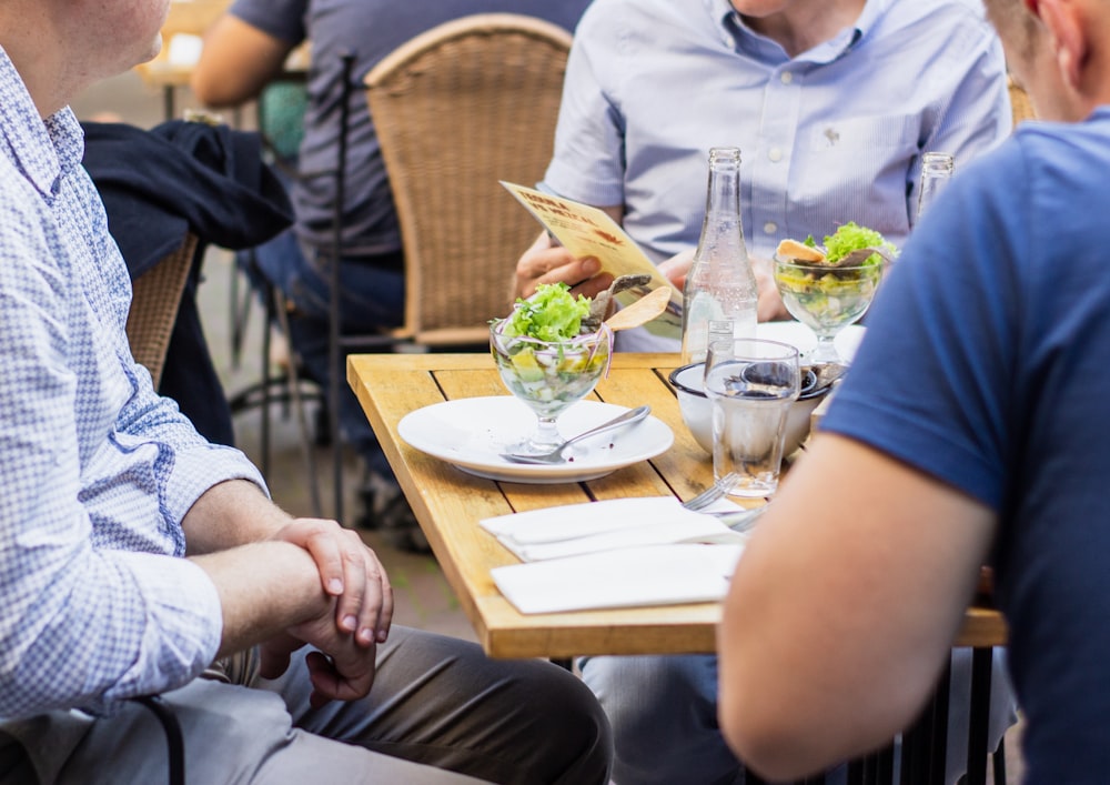 people sitting front of table at daytime