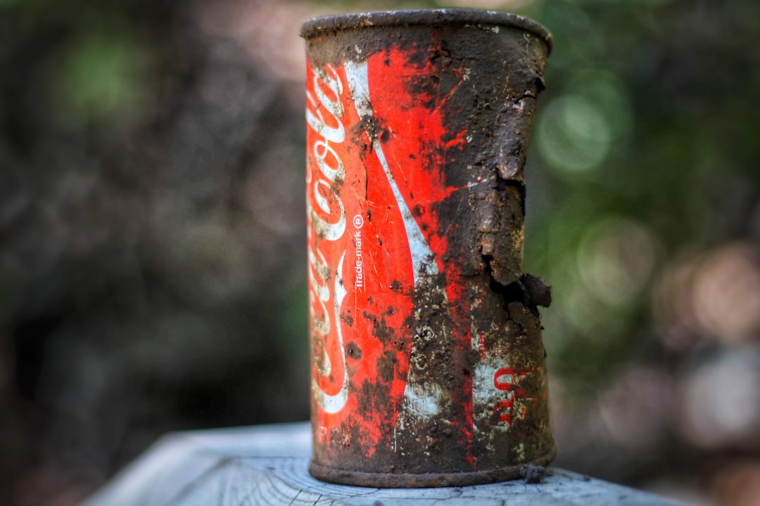 crumpled Coca-Cola beverage tin can