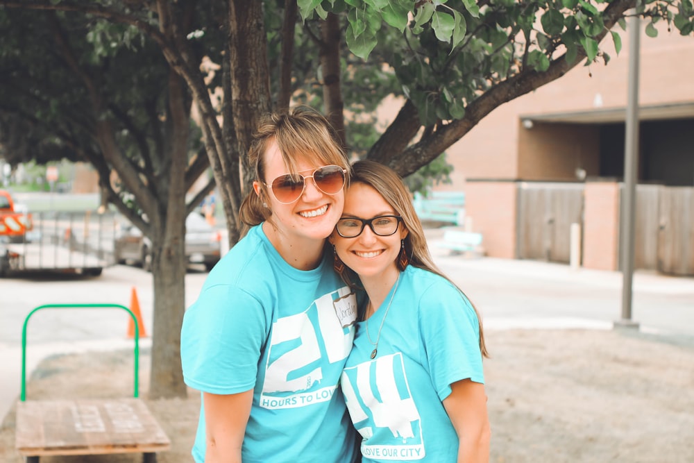 two women wearing blue and white t-shirts during daytime