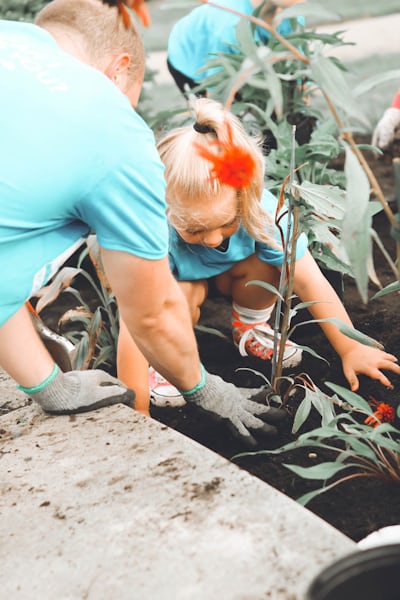 girl in blue top planting outdoors