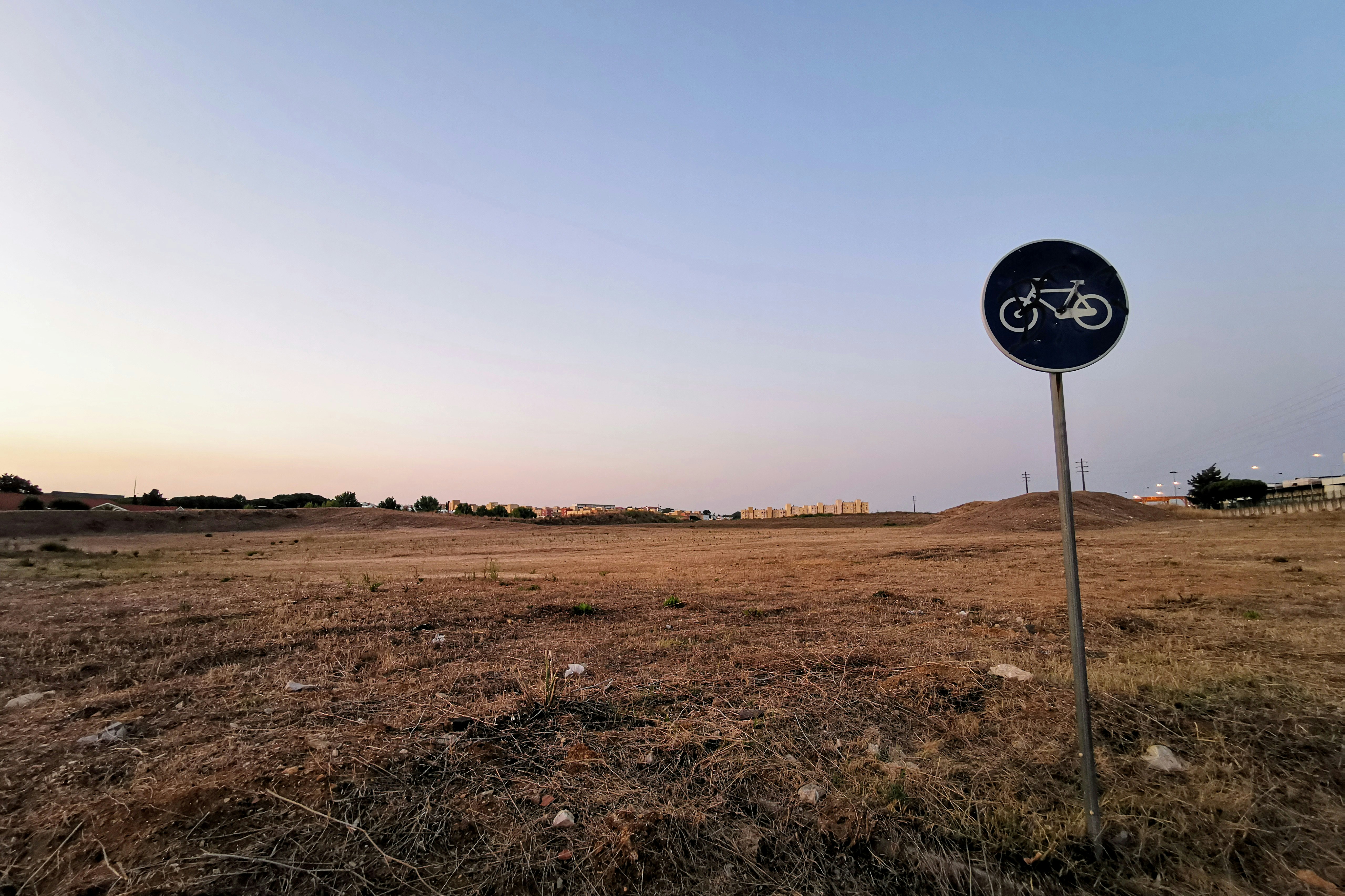 green and white bicycle road sign