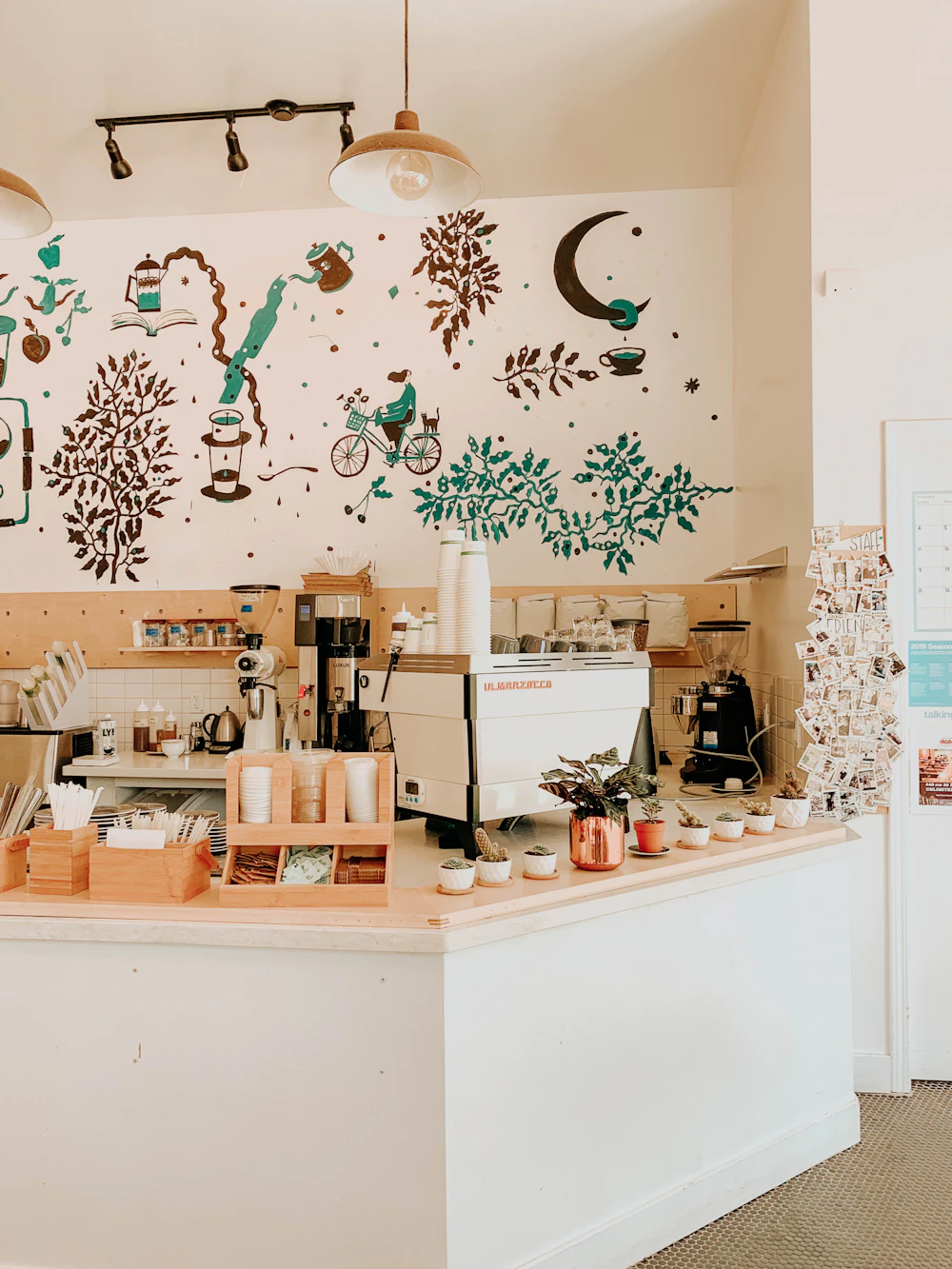 Bonduc's espresso counter with a hand-painted coffee mural on the wall behind it.
