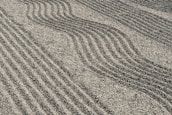 a sandy area with lines drawn in the sand