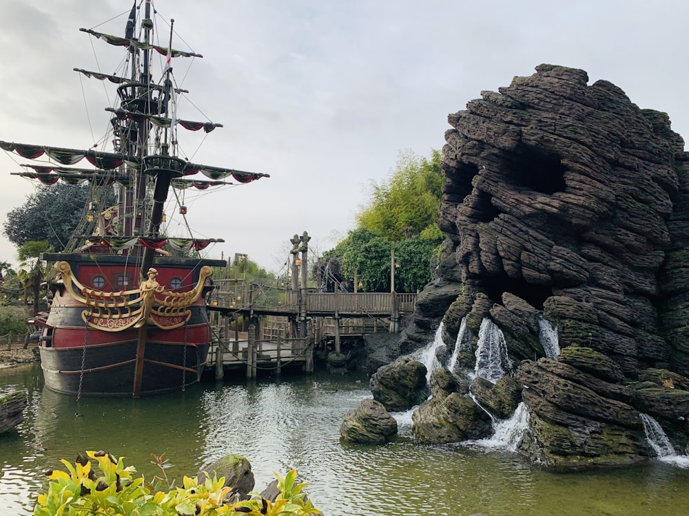 blue and red galleon ship during daytime