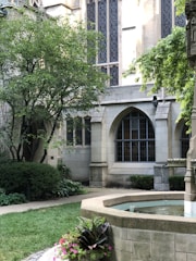 A peaceful courthouse building surrounded by greenery.