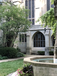 A peaceful courthouse building surrounded by greenery.