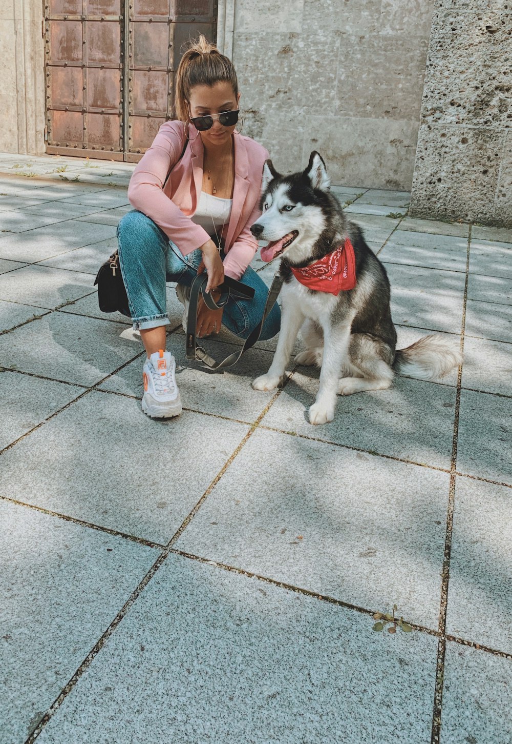 woman kneeling beside Siberian husky