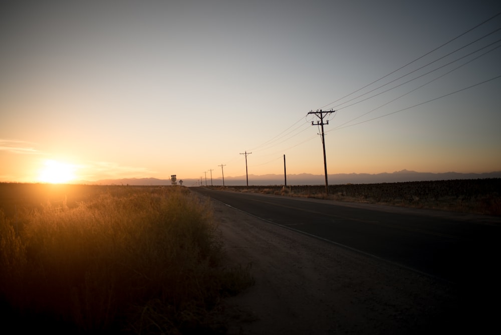 silhouette photo of gray pavement road