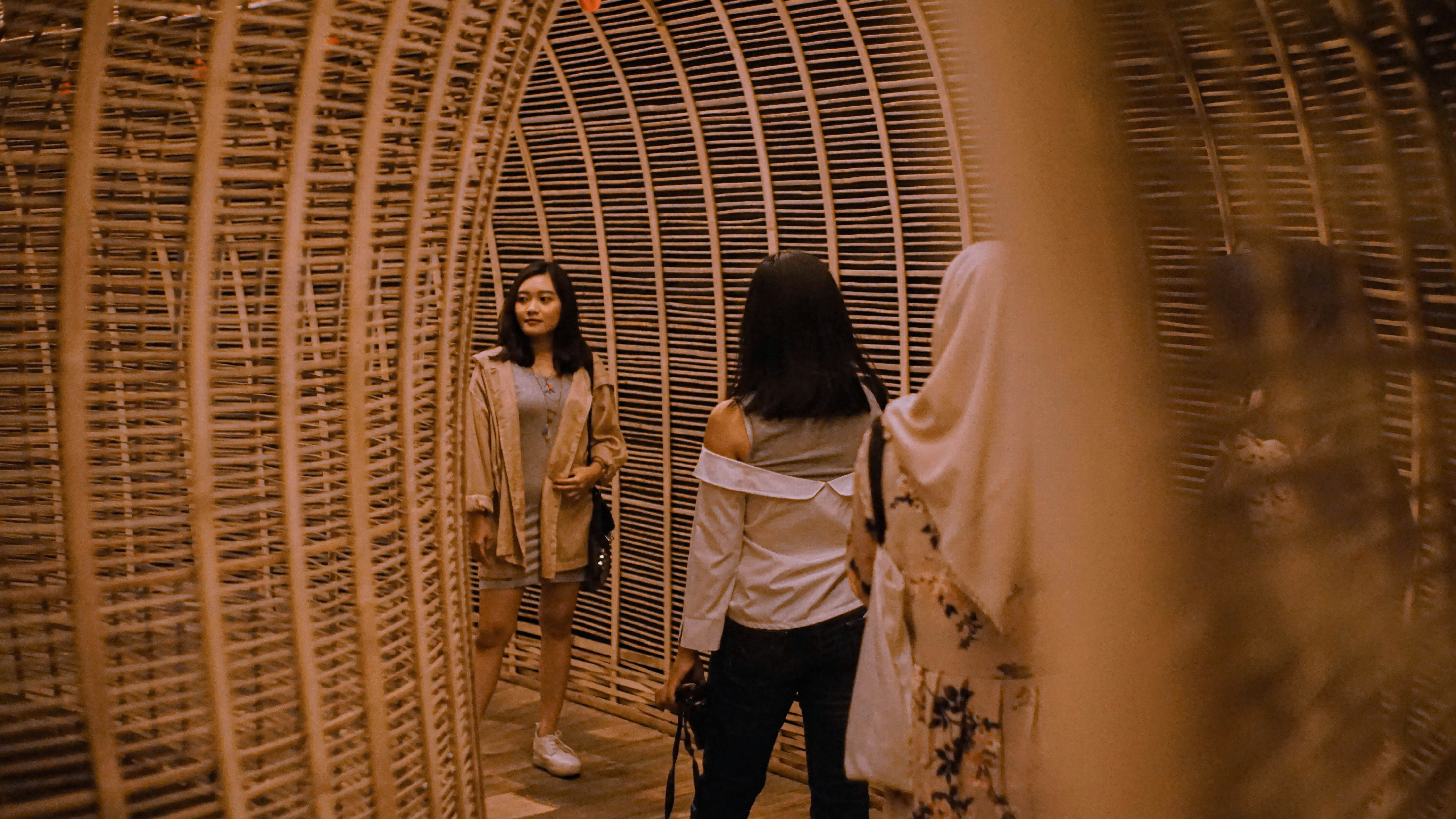 three women standing inside hallway