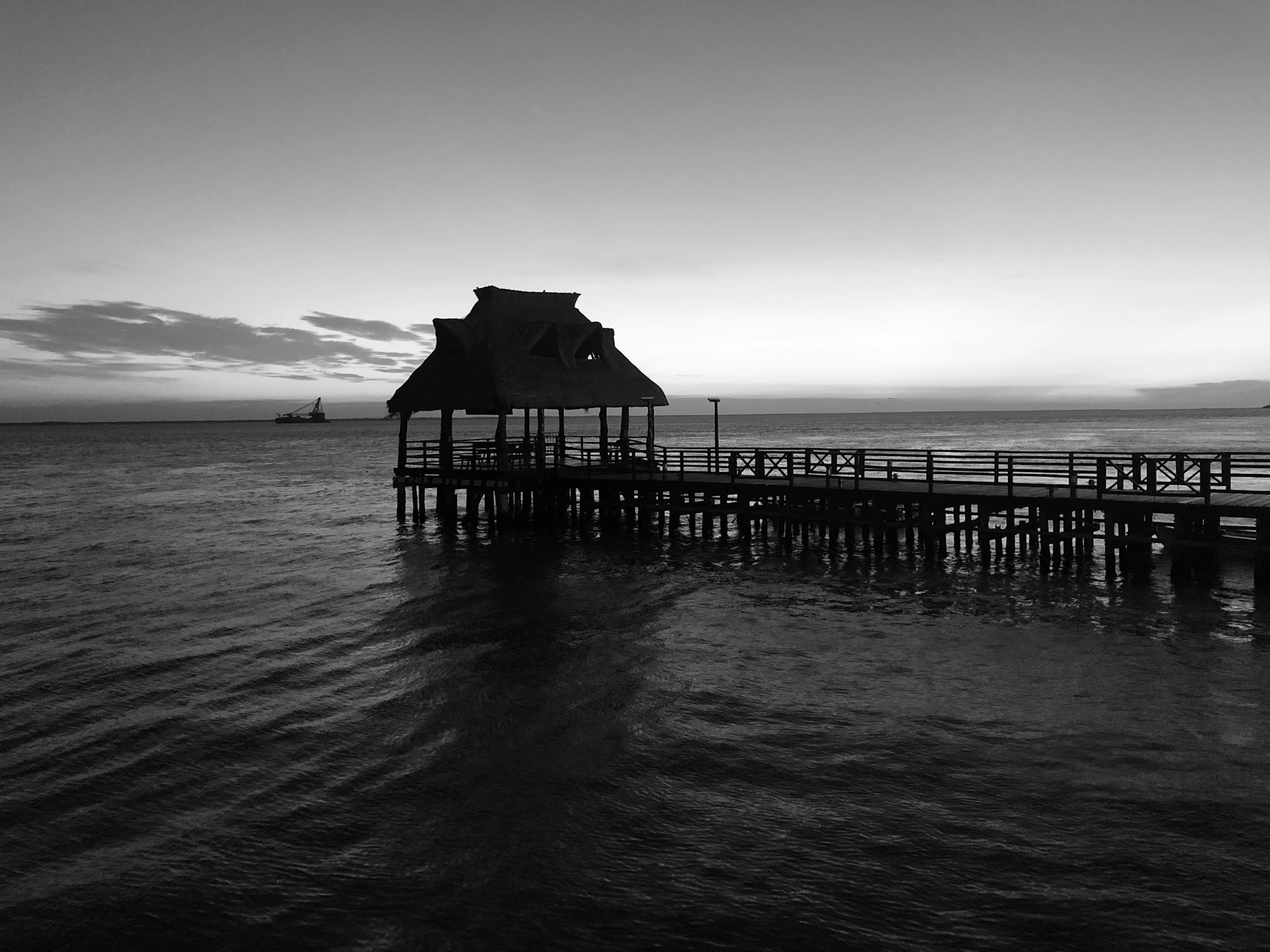 silhouette of beach house and sea