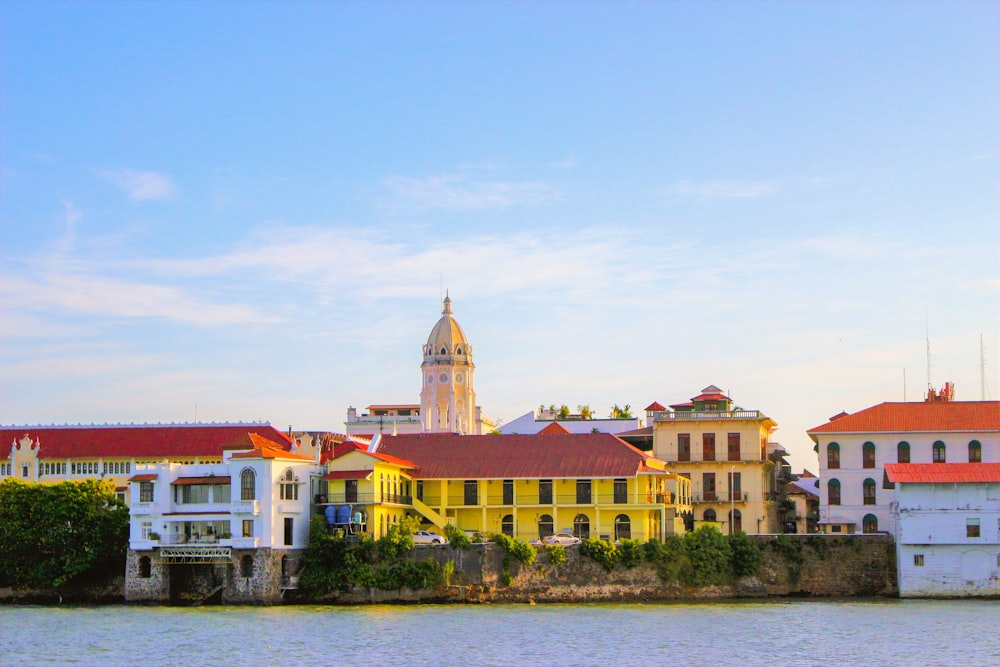 a large body of water next to a row of buildings