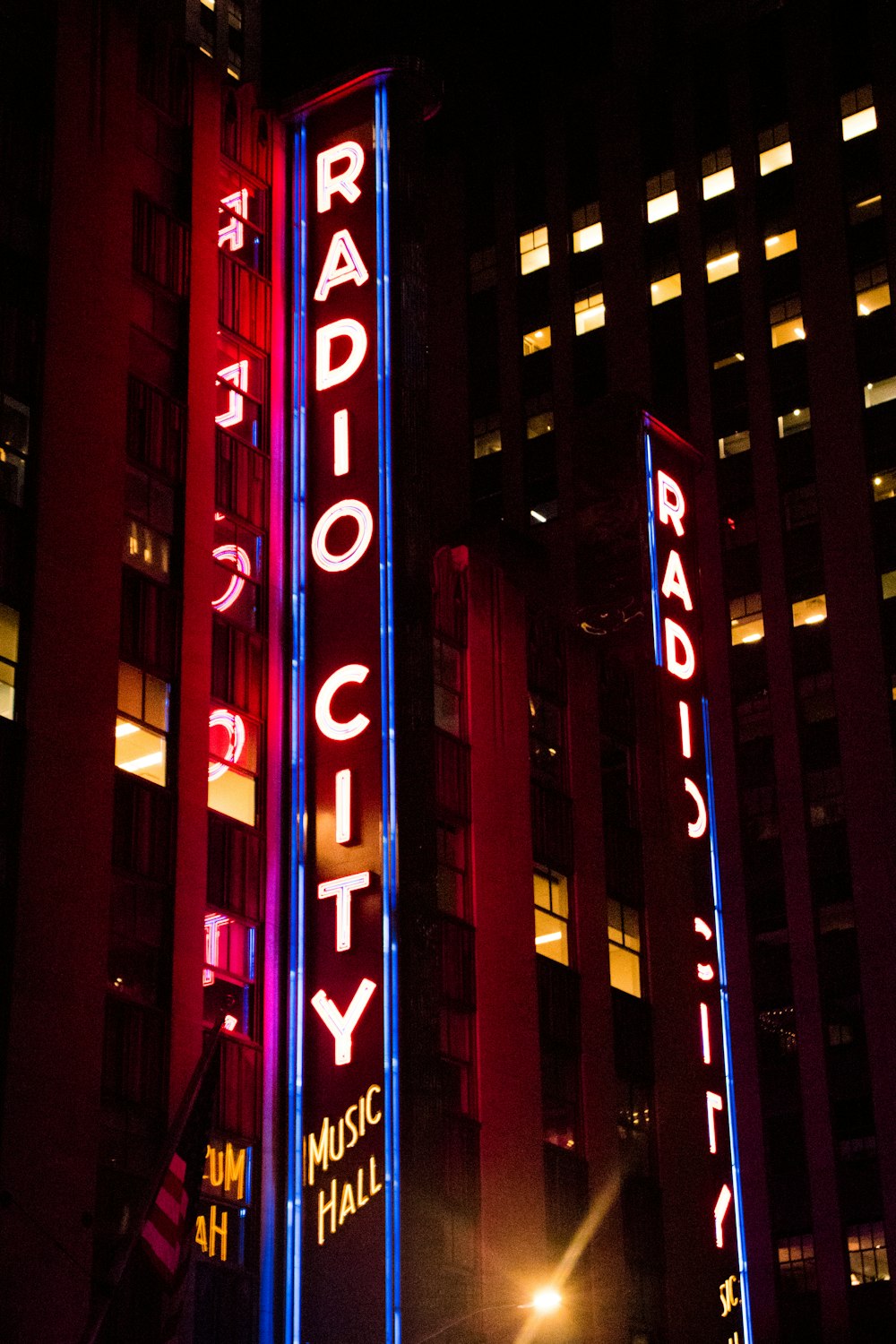 a radio city sign lit up at night