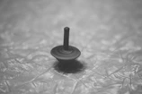 A close-up of a classic spinning top toy in motion.