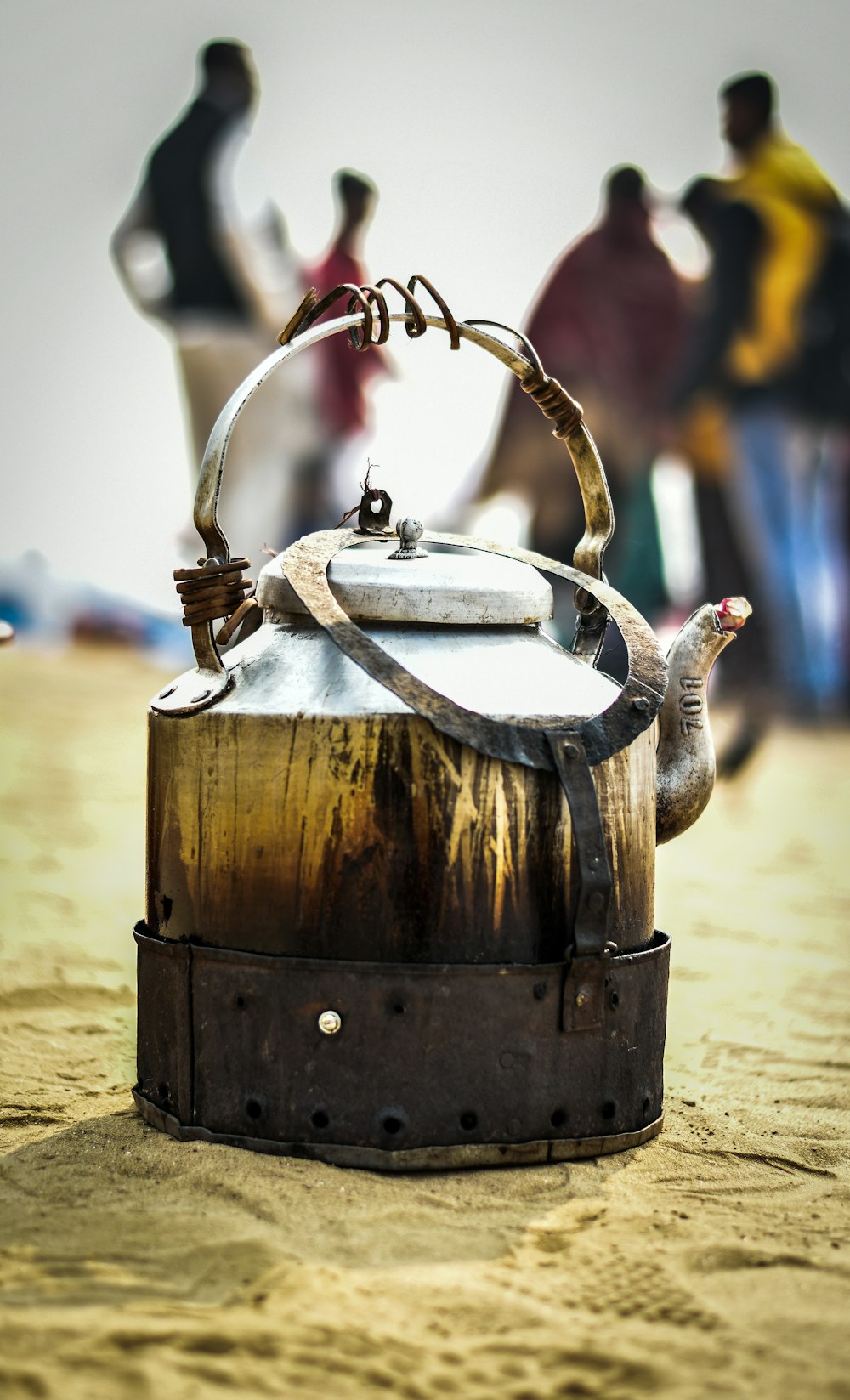 grey teapot on sand