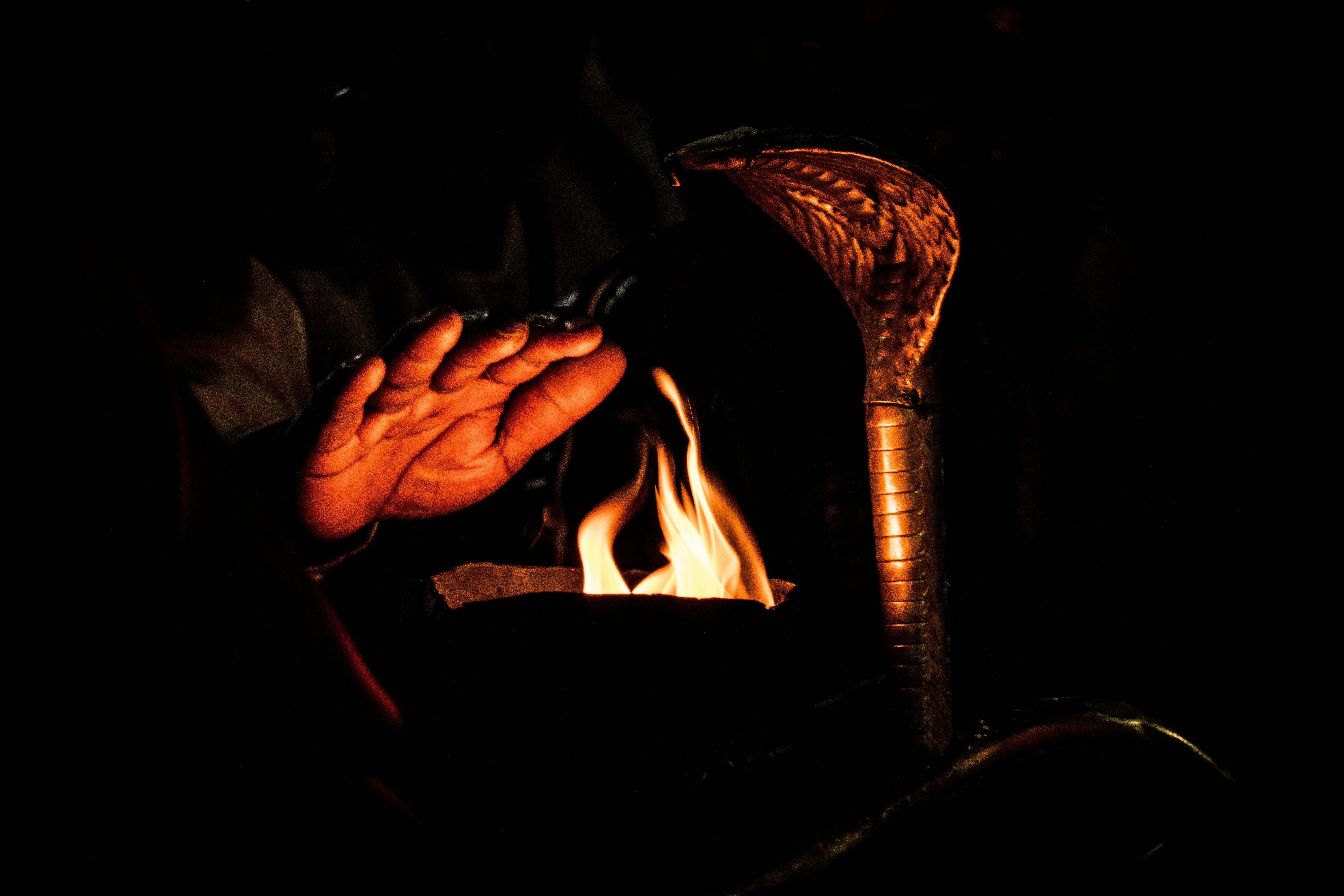 a person holding a lit candle in their hands