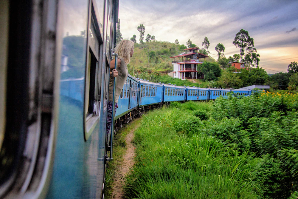 Scenic train travelling through the green hills of Ella Sri Lanka