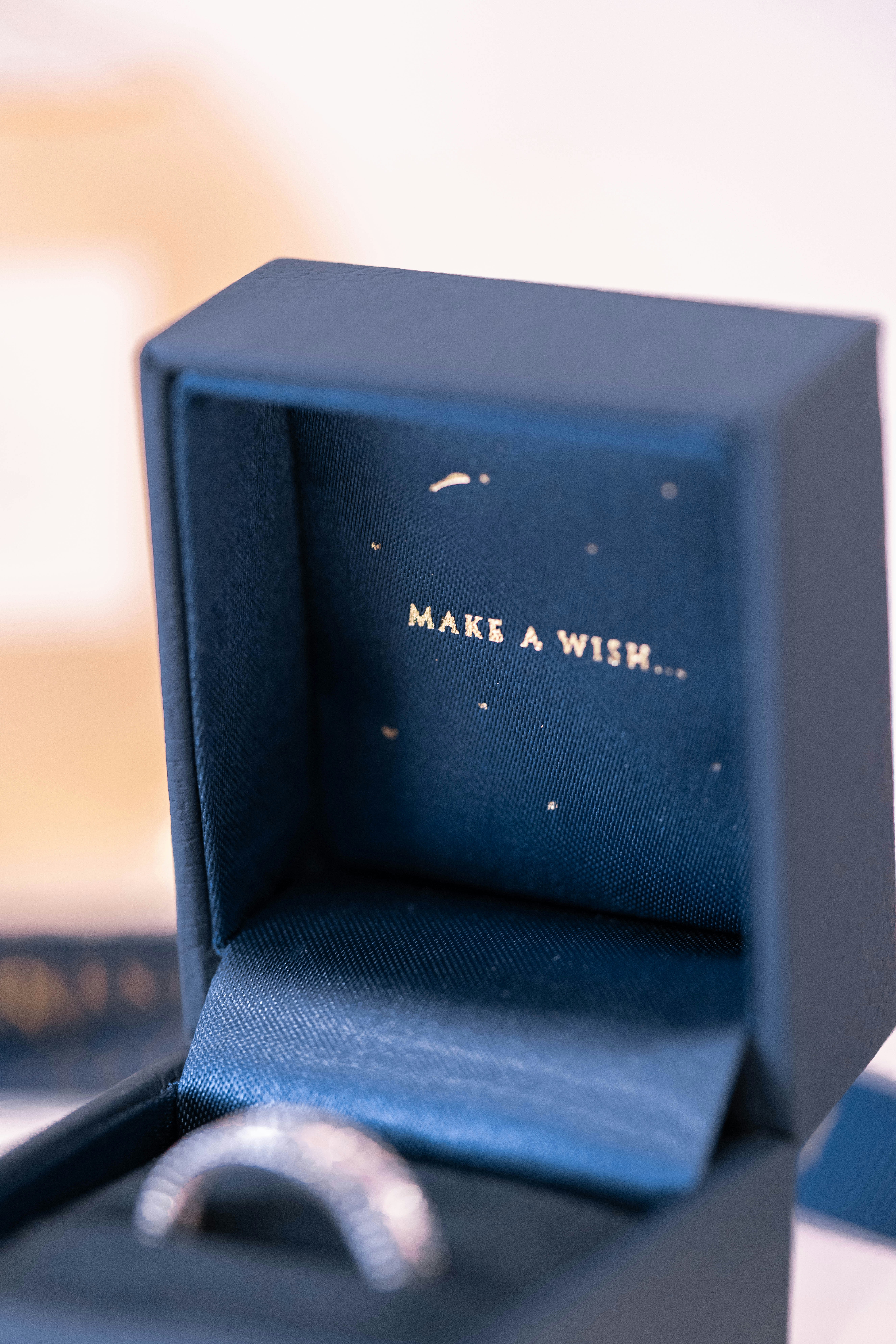 silver-colored ring with box