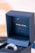 An open dark blue jewelry box with the phrase 'MAKE A WISH...' inscribed in gold on the interior. The box contains a shiny, metallic object, possibly a ring, partially visible at the bottom.