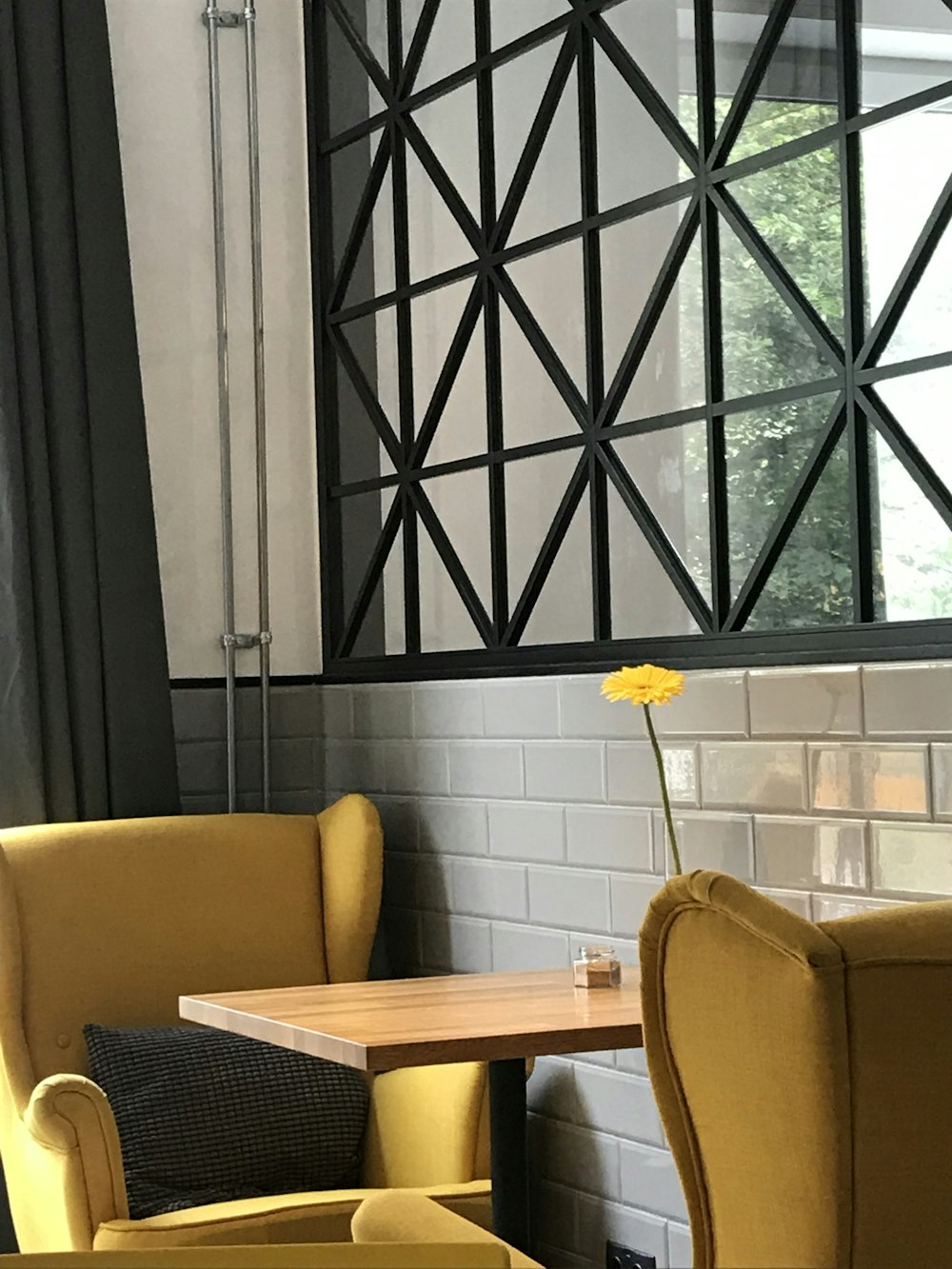 two yellow sofa chairs and brown wooden table