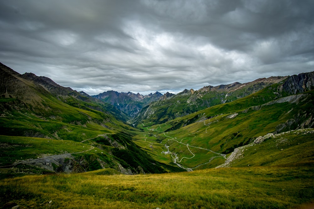 green open field viewing mountain during daytime