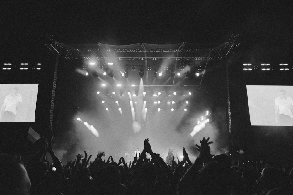 Outdoor concert audience under evening lights