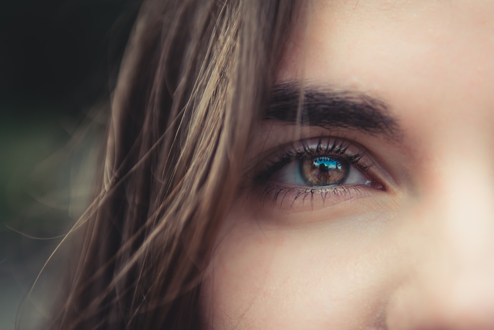 a close up of a woman's blue eyes