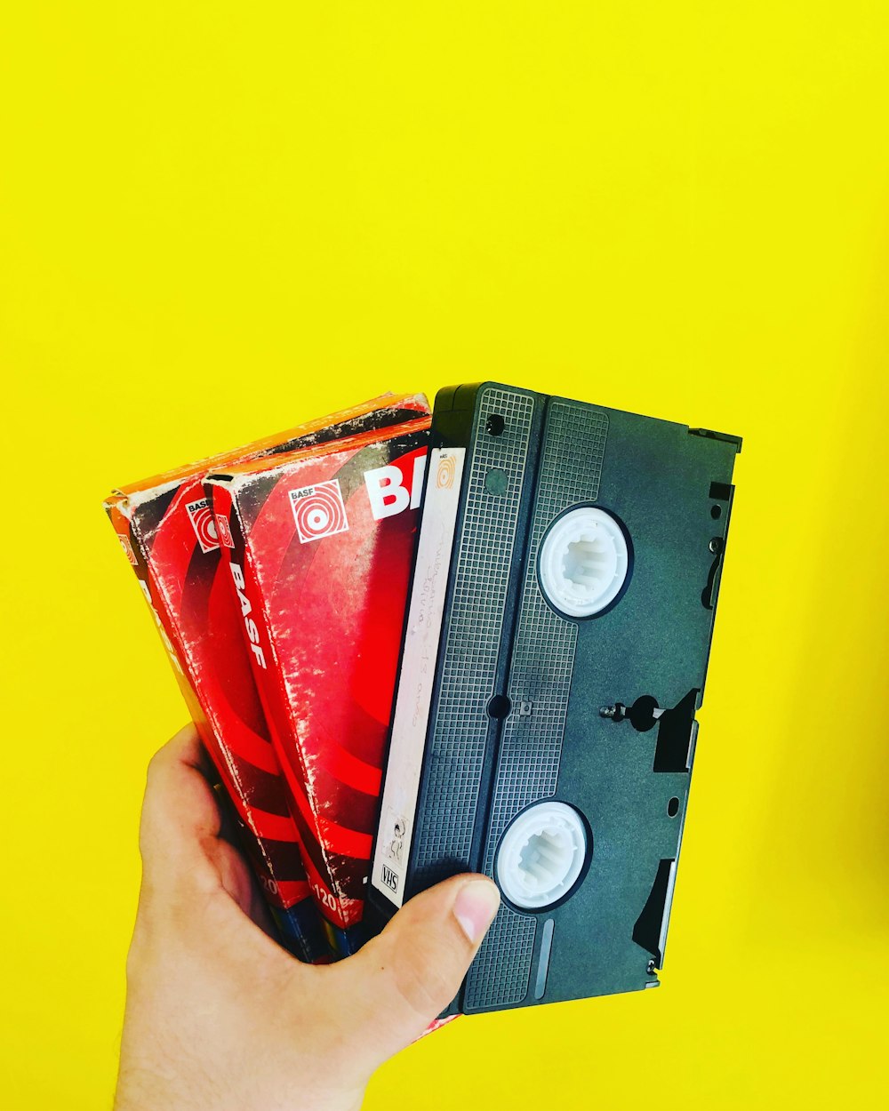 person holding black cassette