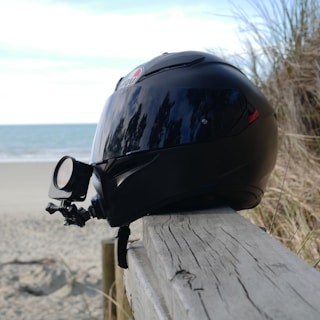 Side view of a rider wearing the helmet with the mount, capturing smooth, centered POV footage on a winding road.