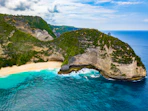 aerial photography of island surrounded by water under white sky