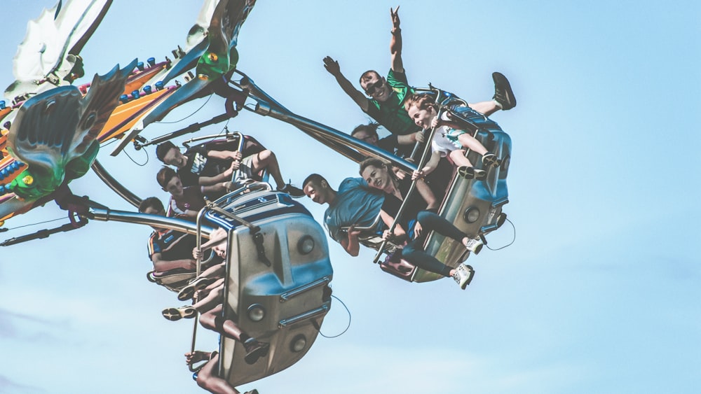 people riding amusement ride during daytime