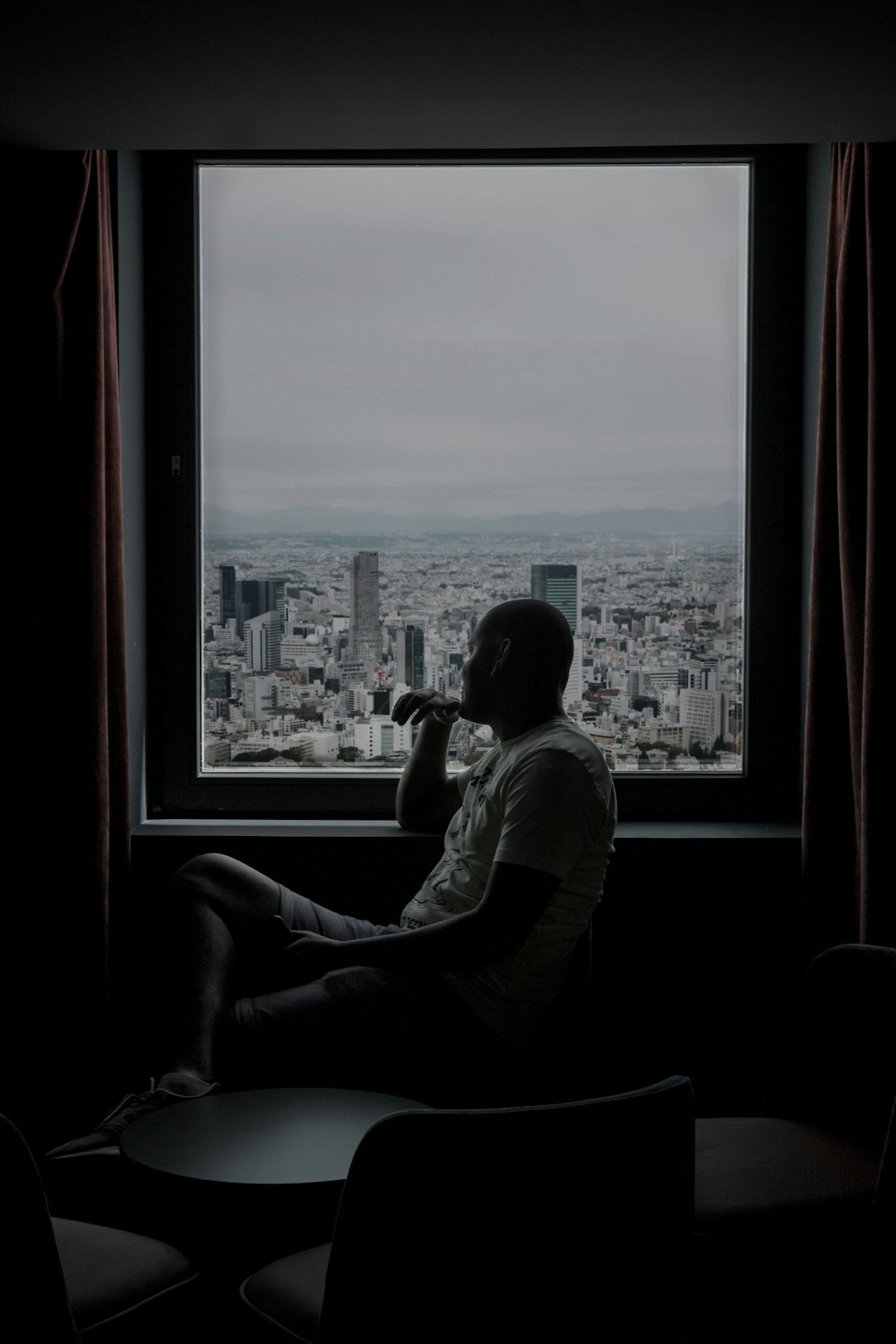 man sitting in front of window