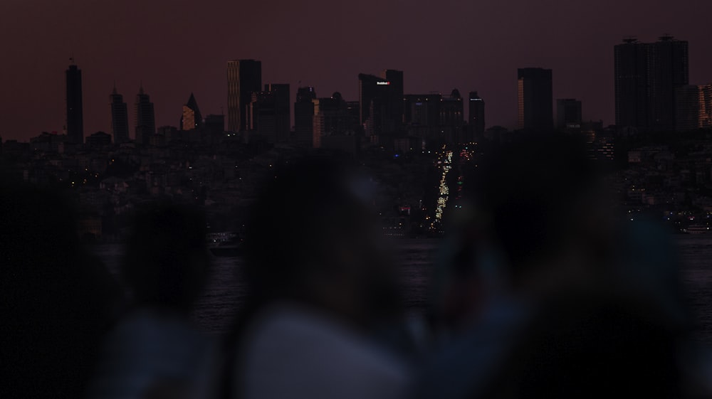 a group of people standing next to each other in front of a city