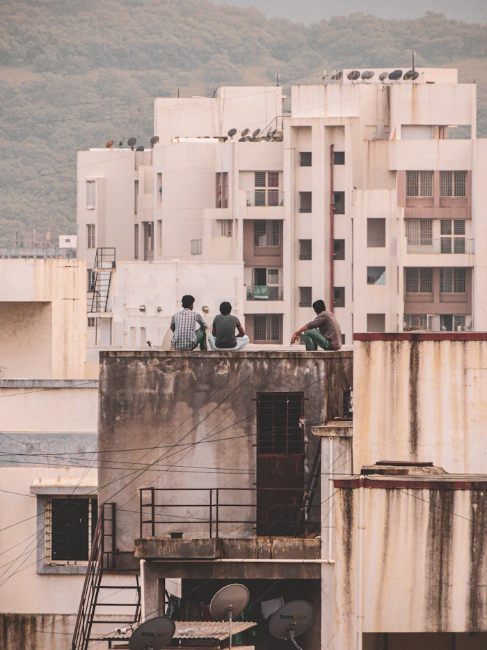 Three people sitting together on a rooftop