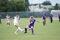 Dynamic action shot of two players contesting for the ball in a high-stakes Premier League game.