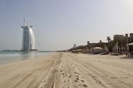 A beachfront property in the UAE with lounge chairs facing the sea.