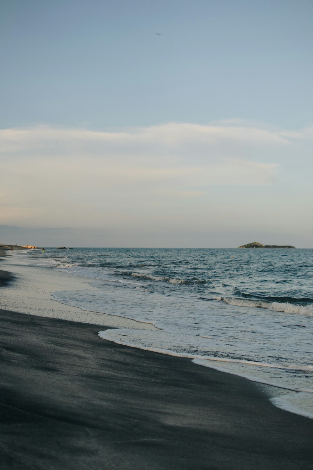 a beach with waves coming in to shore