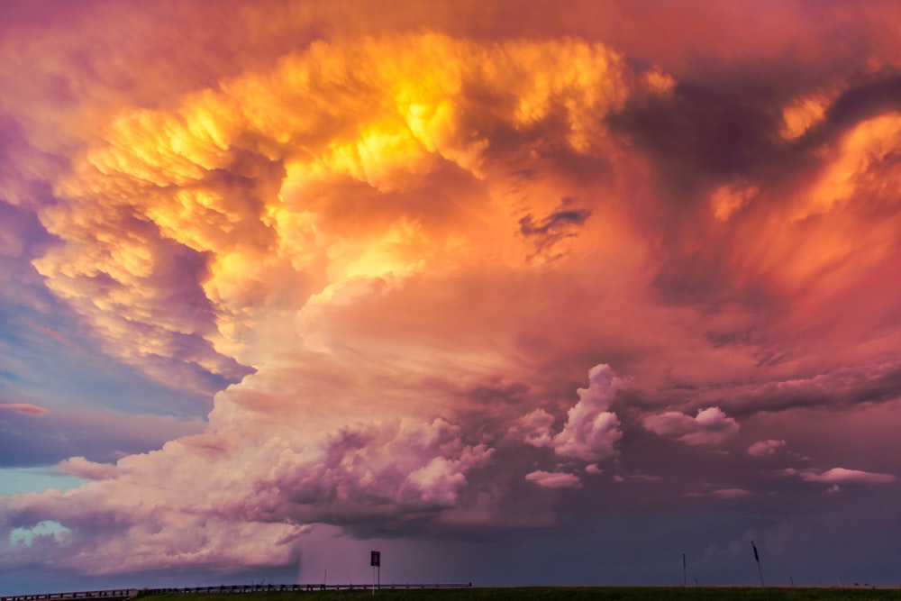 panache de nuages orangés au coucher du soleil