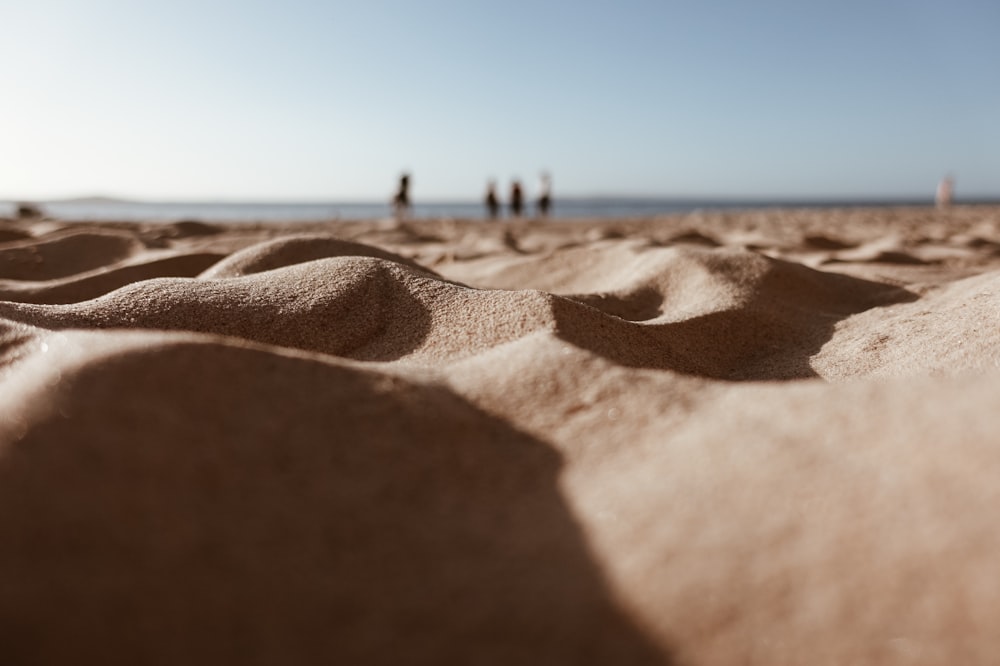 low-angle photography of sand under white sky