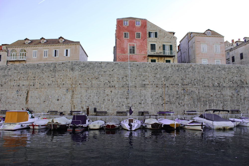 boats near concrete wall